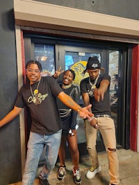 three people posing for a picture in front of a door