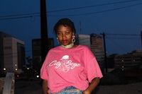 a woman wearing a pink tee shirt and jeans