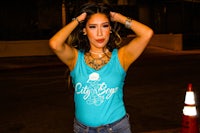 a woman wearing jeans and a tank top
